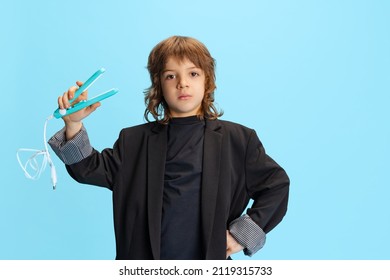 Hair Fashion Stylist. Studio Shot Of Liitle Cute Boy, Kid In Image Of Stylish Hairdresser, Barber Isolated On Blue Background. Concept Of Occupation, Emotions, Childhood, Studying