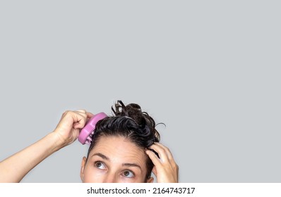 hair growth stimulating, scalp massage.woman using  pink scalp massager shampoo brush with silicone,flexible bristels.hair care,head relaxation.shampoo foam on hair,hand,isolated - Shutterstock ID 2164743717