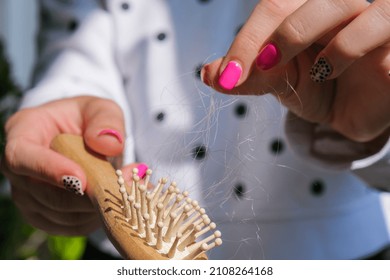 Hair loss on the comb, massage wooden brush with a clump of hair, problem of growth, hair care problems. Hair loss it cause from family history, hormonal changes, unhealthy of aging.