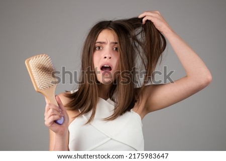 Hair loss woman with a comb and problem hair. Hairloss stressed woman and bald problems.