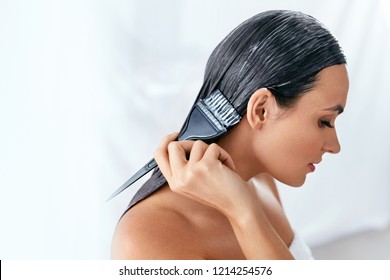 Hair Mask. Woman Applying Conditioner On Long Hair With Brush, Hair Care Treatment