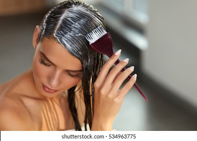 Hair Masking. Young Woman With Brush In Hand Applying Natural Mask On Long Healthy Hair. Beautiful Girl Spreading Conditioner Along Wet Hair. Health And Beauty. High Resolution Image