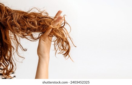 Hair problems. Female person showing her damaged and dry hair. - Powered by Shutterstock