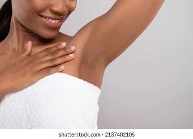 Hair Removal Concept. Unrecognizable Black Female Demonstrating Her Armpit With Smooth Skin, Smiling African American Woman Wrapped In Bath Towel Standing Over Grey Background, Copy Space - Shutterstock ID 2137402105