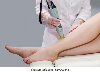 Hair Removal Cosmetology Procedure From A Therapist At Cosmetic Beauty Spa Clinic. Laser Epilation. Cosmetology And SPA Concept. 