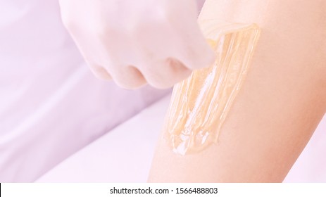 Hair Removal At Spa Luxury Studio. Woman Legs Wax With Shugaring. Hot Sugar.