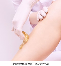 Hair Removal At Spa Luxury Studio. Woman Legs Wax With Shugaring. Hot Sugar.