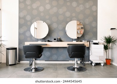 A hair salon with two chairs and two mirrors - Powered by Shutterstock