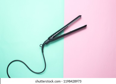 Hair Straightener On Pastel Background. Top View. Minimalism
