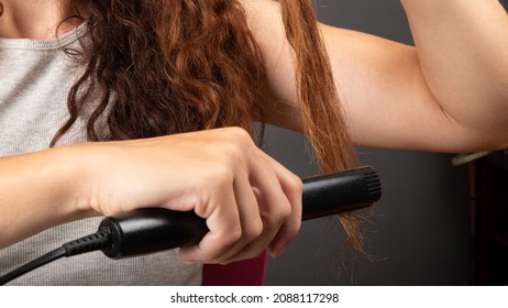 hair straightening with an iron, beauty hair care.
 - Shutterstock ID 2088117298
