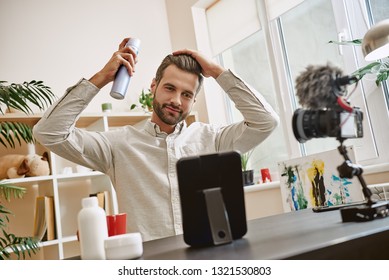 Hair Styling. Cheerful Male Beauty Blogger Recording Video Blog Episode About New Hair Spray.