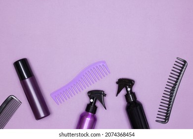 Hair Styling Products With Combs Top View On Purple Background. Copy Space