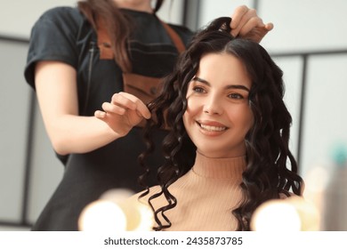 Hair styling. Professional hairdresser working with smiling client indoors, closeup - Powered by Shutterstock