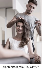 Hair Stylist Doing Hairstyle For Young Woman