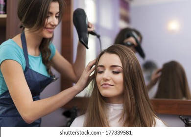 Hair Stylist Drying Woman's Hair