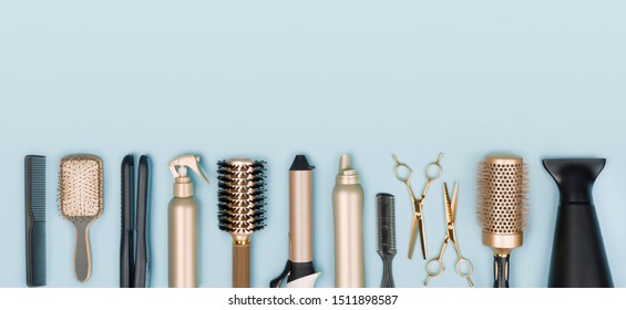Hair Stylist Tools Arranged In A Line On Blue Background