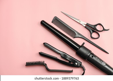 Hair Stylist Tools On A Pink Background. Scissors, Brush, Comb, Curling Iron. Home Hair Care. Beauty Salon Tools. Hairdresser's Equipment. Top View, Flat Lay