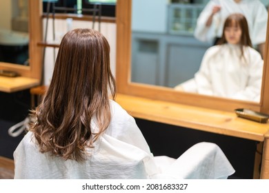 Hair Stylist Using A Hair Iron