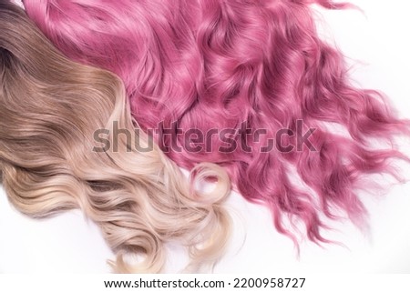 A hair texture of two hair colours: honey blond and rose pink closeups, a wavy shiny texture, isolated on white