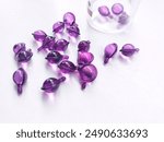 Hair vitamin capsules over white background.