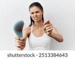 Hairbrush, hair loss, frustrated woman, unhealthy hair, hair care problems, light background