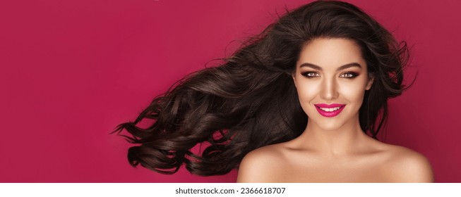 Haircare. Beautiful Brunette Woman Portrait with brown eyes and Healthy Long Shiny Wavy black hair. Volume shampoo. Attractive Beauty model with professional make up against pink background - Shutterstock ID 2366618707