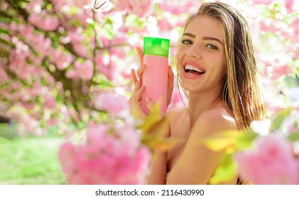 Haircare. Smiling Girl With Hair Balsam Or Shampoo. Beautiful Woman With Organic Cosmetics For Hair.