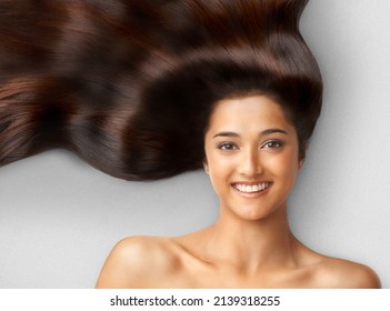 Haircare. Studio Shot Of A Beautiful Young Woman With Long Brown Hair.