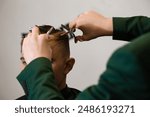 Haircut and alignment of the contour of the head with scissors. Short haircut in the barbershop.