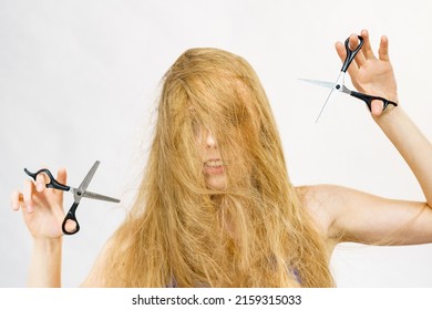 Haircut coiffure haircare concept. Girl with blowing long blond hair holding scissors, showing work tools, normal and thinning shears.