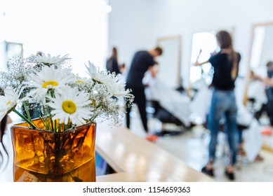 haircut saloon on background. chamomile in vase close up - Shutterstock ID 1154659363