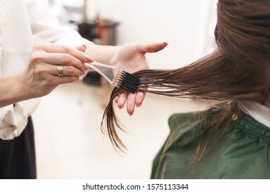 Hairdresser Applies A Hair Mask To The Woman In The Beauty Salon. Botox And Keratin Hair Straightening Procedure