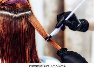 Hairdresser Applies A Hair Mask To The Woman In The Beauty Salon. Botox And Keratin Hair Straightening Procedure