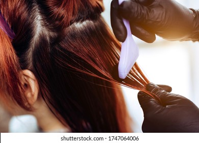 Hairdresser Applies A Hair Mask To The Woman In The Beauty Salon. Botox And Keratin Hair Straightening Procedure