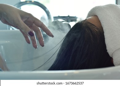 Hairdresser In Beauty Salon Massage Head Customer And Hair Care In Procedure Of Steaming Water Steam. Service Steaming Ozone In Spa And Salon Shop.