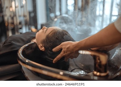 Hairdresser in beauty salon massage head customer and hair care in procedure of steaming water steam. Customer feeling relax while hairdresser massaging head at beauty barber shop - Powered by Shutterstock