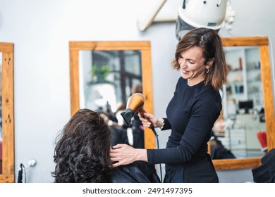 A hairdresser blow dries a client's hair in the salon, creating a voluminous and shiny look. Concept of professional hair styling and client care. - Powered by Shutterstock