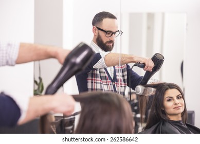 Hairdresser Blow Dry Beautiful  Woman Hair In Hairdressing Salon.