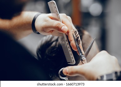 Hairdresser with a client. Man with a beard. Guy in a barbershop - Powered by Shutterstock