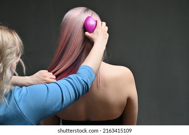 Hairdresser Combing Model's Hair From Behind