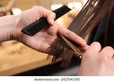 Hairdresser cutting client's hair with scissors in salon, closeup - Powered by Shutterstock