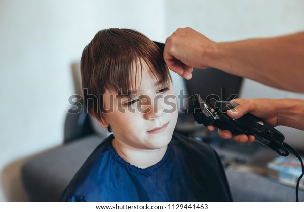 Hairdresser Does Haircut Clipper Boy Stock Photo Edit Now 1129441463