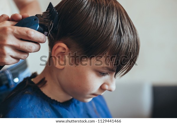 Hairdresser Does Haircut Clipper Boy Stock Photo Edit Now 1129441466