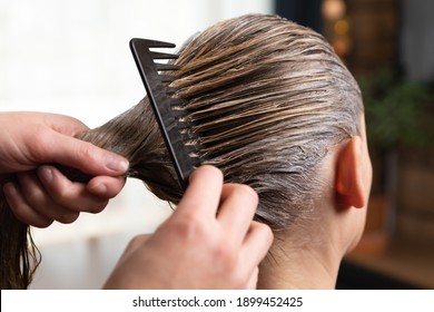 Hairdresser Doing Treatment After Applying Hair Coloring , Hair Dye For A Blonde Women At Home Or Salon.