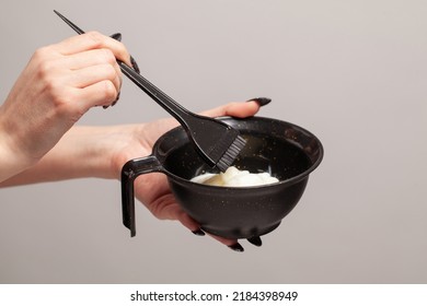 Hairdresser holding bowl with hair dye closeup  - Shutterstock ID 2184398949