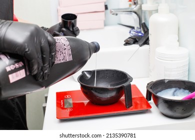 hairdresser holding bowl and preparing hair dye in beauty salon close - Powered by Shutterstock