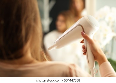 Hairdresser Holding Hair Dryer