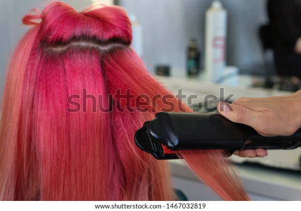 Hairdresser Makes Hairstyle Client Using Crimping Stock Photo