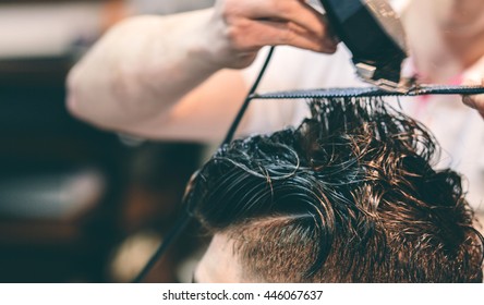 Hairdresser Makes Hairstyle A Man With A Clip On The Head In A Hairdressing Salon