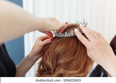 Hairdresser Makes Models Hairstyle For Bride, Putting On Tiara Crown. Close-up Shot With No Face